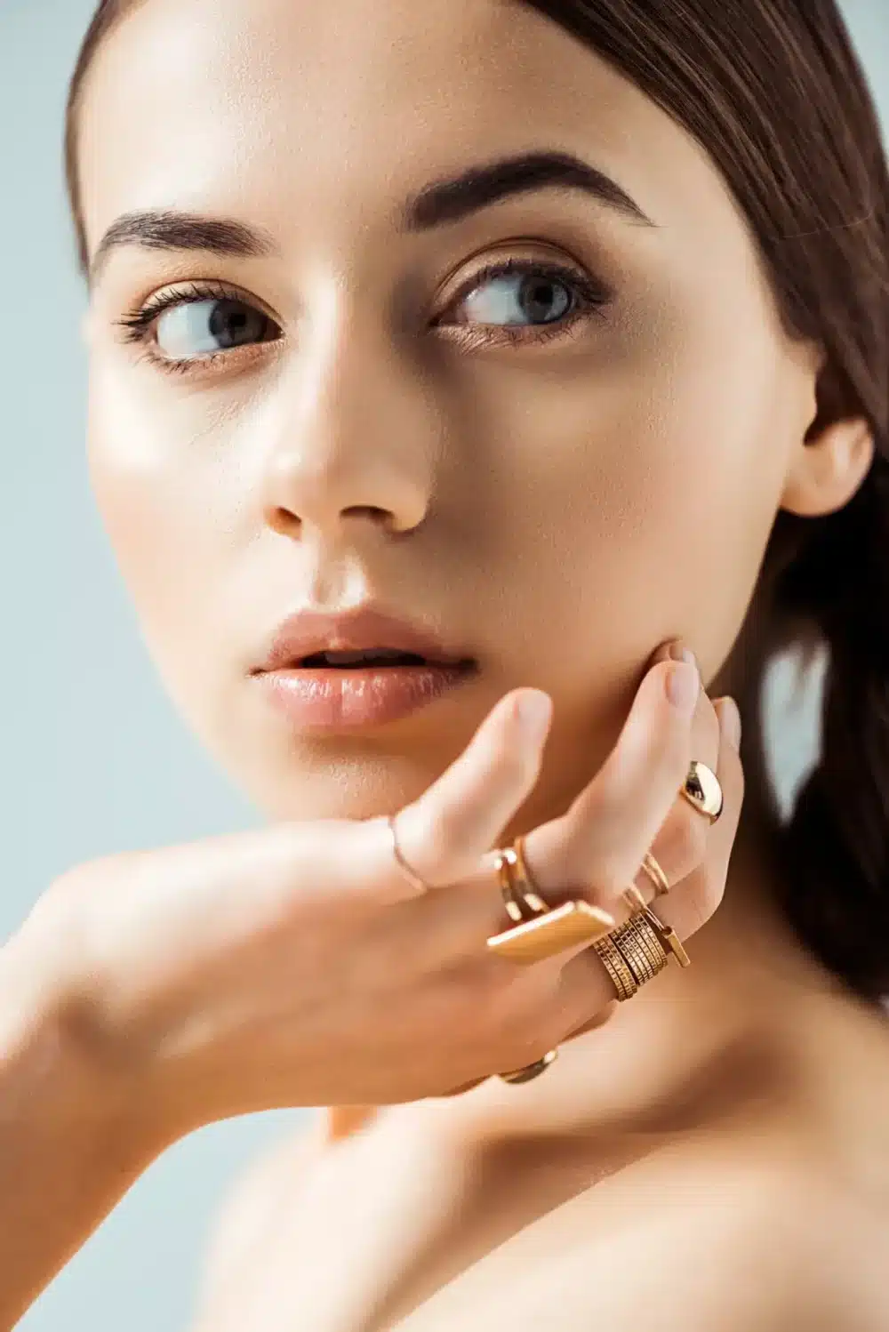 young-woman-with-shiny-makeup-and-golden-rings-loo-2024-11-08-23-25-31-utc